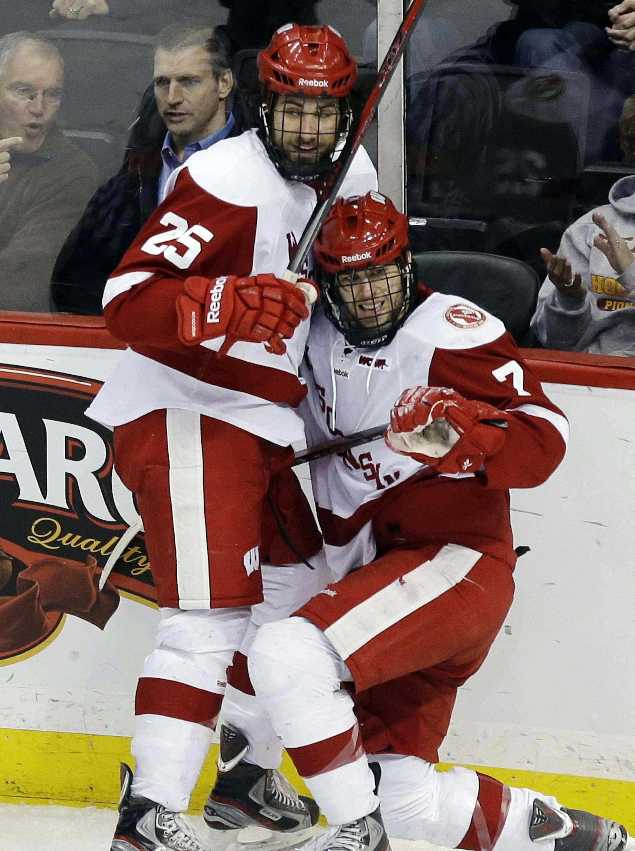 Wisconsin's Michael Mersch (25) congratulates Tyler Barnes on Barrnes' goal in the second period of the WCHA Final Five quarterfinals college hockey game against Minnesota State, Mankato, Thursday, March 21, 2013, in St. Paul, Minn. Wisconsin won 7-2. (AP Photo/Jim Mone) ORG XMIT: MIN2013032117154310