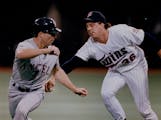 Twins pitcher Kevin Tapani, here tagging out the Angels’ Chad Curtis in 1993 at the Metrodome, confirmed that his roots in Upper Michigan go back to