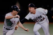 Twins pitcher Kevin Tapani, here tagging out the Angels’ Chad Curtis in 1993 at the Metrodome, confirmed that his roots in Upper Michigan go back to