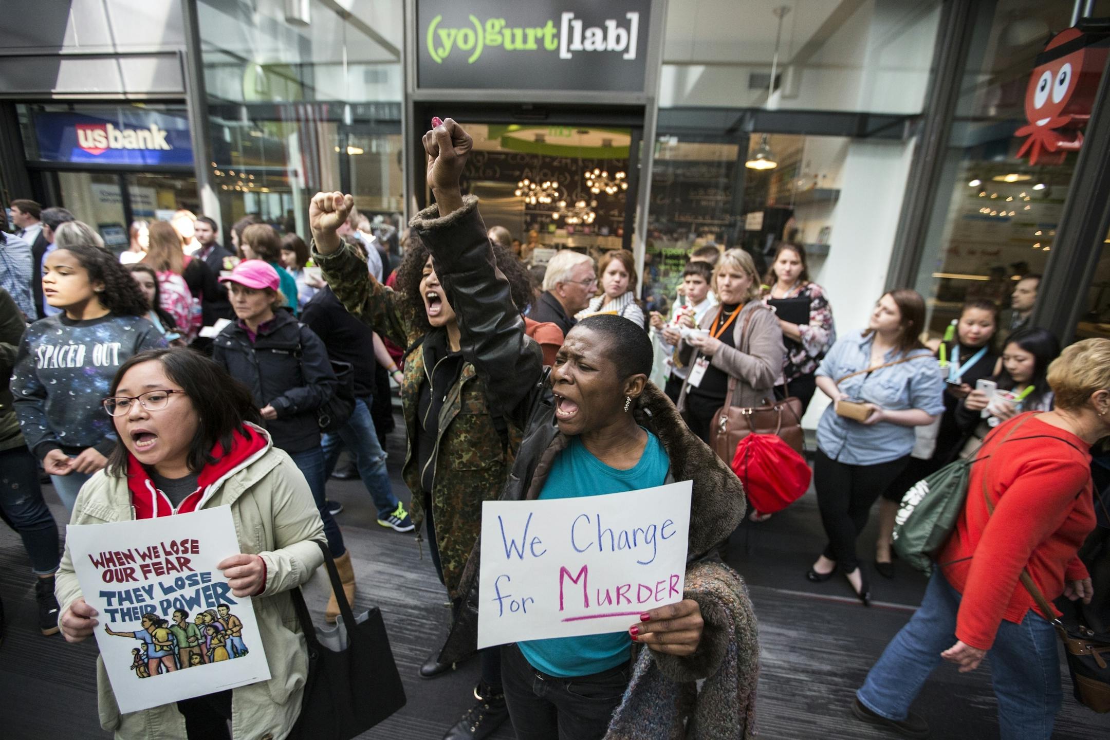 Daphne Brown chants with others during the "Freeman Friday" protest march through the skyways at the IDS Center.