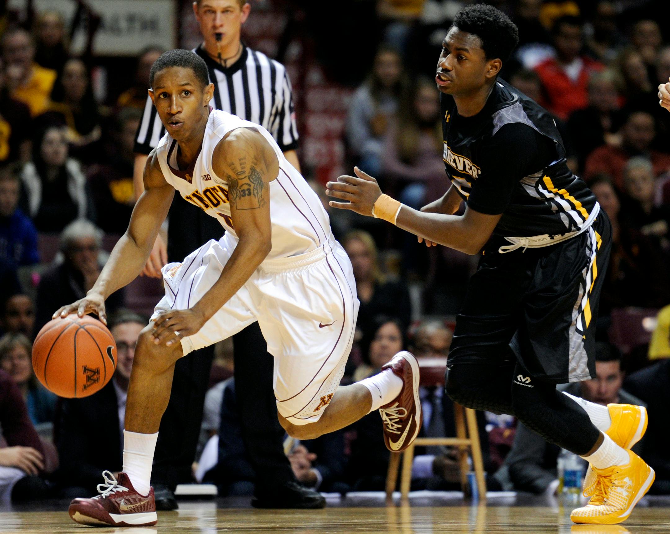 Minnesota guard Deandre Mathieu, left, dribbles against Maryland-Baltimore County guard Jourdan Grant (5) in November. Mathieu is second in the Big Ten in assists per game (6.2) and leads the league in assist-turnover ratio (4-to-1).