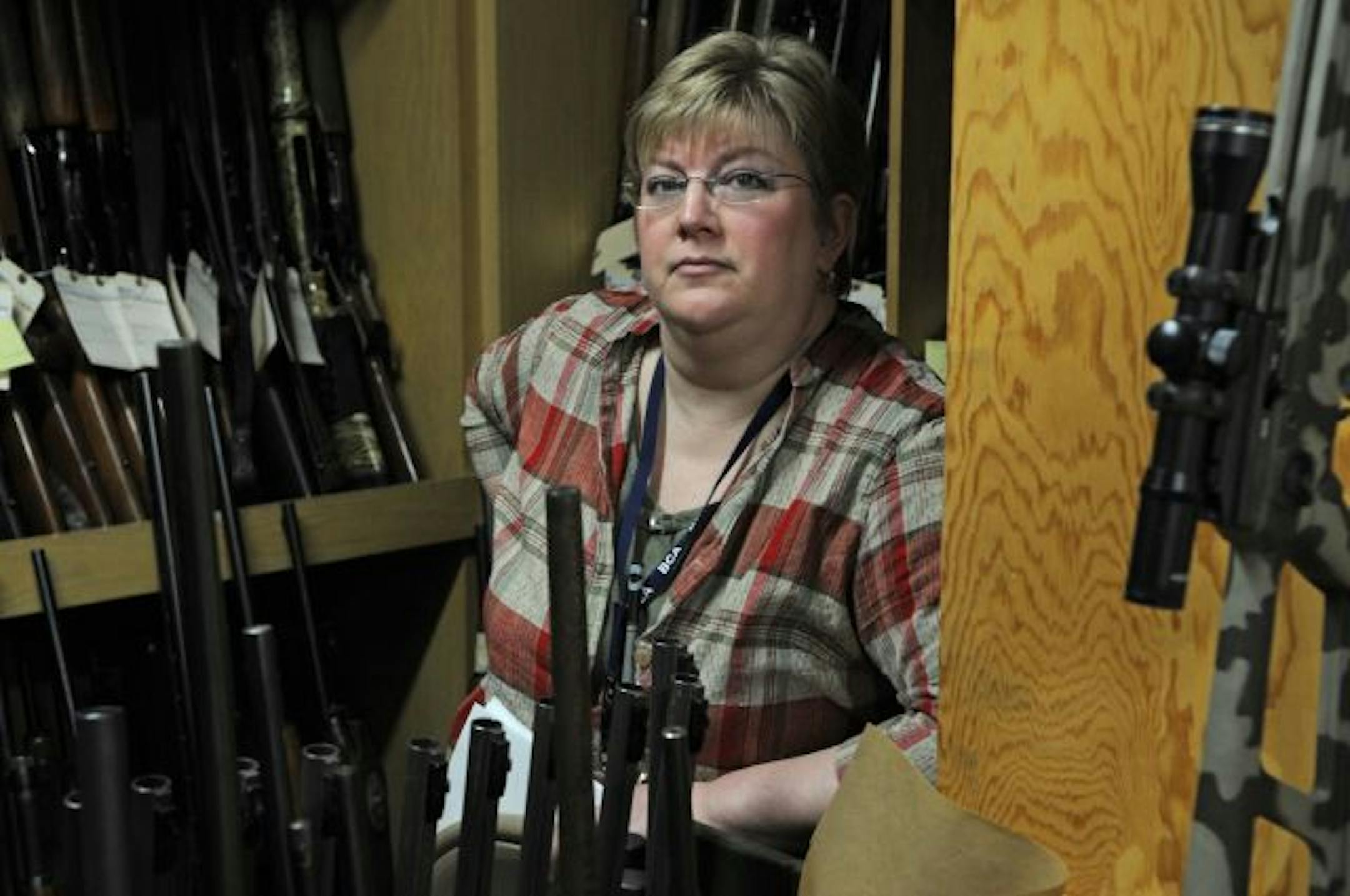 Patty Holt of the Minnesota DNR Arrest and Confiscations in the gun room that she has organized and catalogued for the auction.