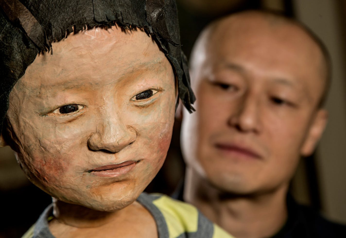 Masanari Kawahara posed with a puppet that he created of himself as a little boy.