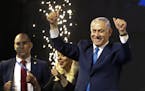 Israel's Prime Minister Benjamin Netanyahu waves to his supporters after polls for Israel's general elections closed in Tel Aviv, Israel, Wednesday, A