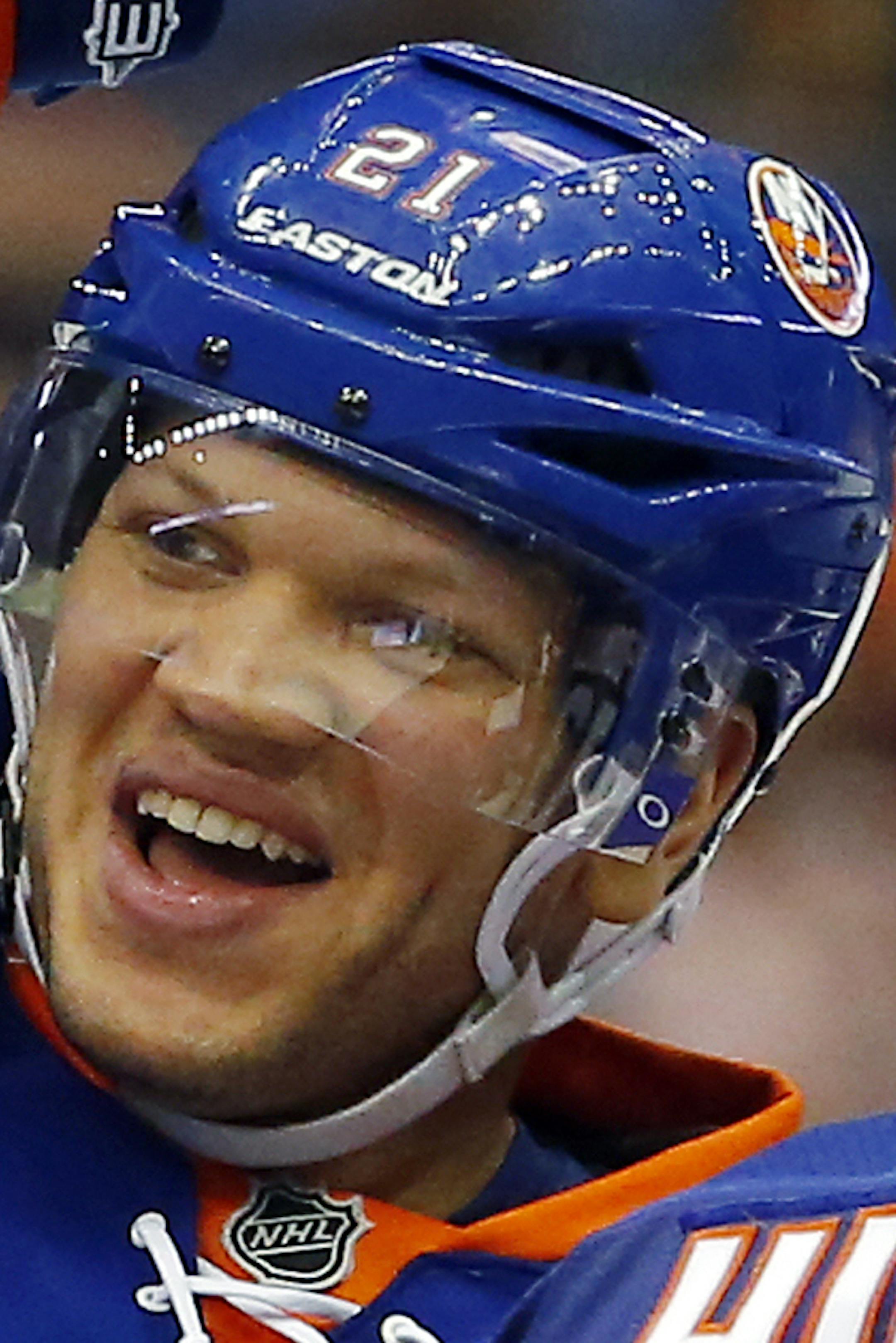 New York Islanders center Keith Aucoin (10) and Kyle Okposo (21) celebrate their 4-1 win over the Philadelphia Flyers in an NHL hockey game in Uniondale, N.Y., Tuesday, April 9, 2013. (AP Photo/Paul J. Bereswill) ORG XMIT: NYI110