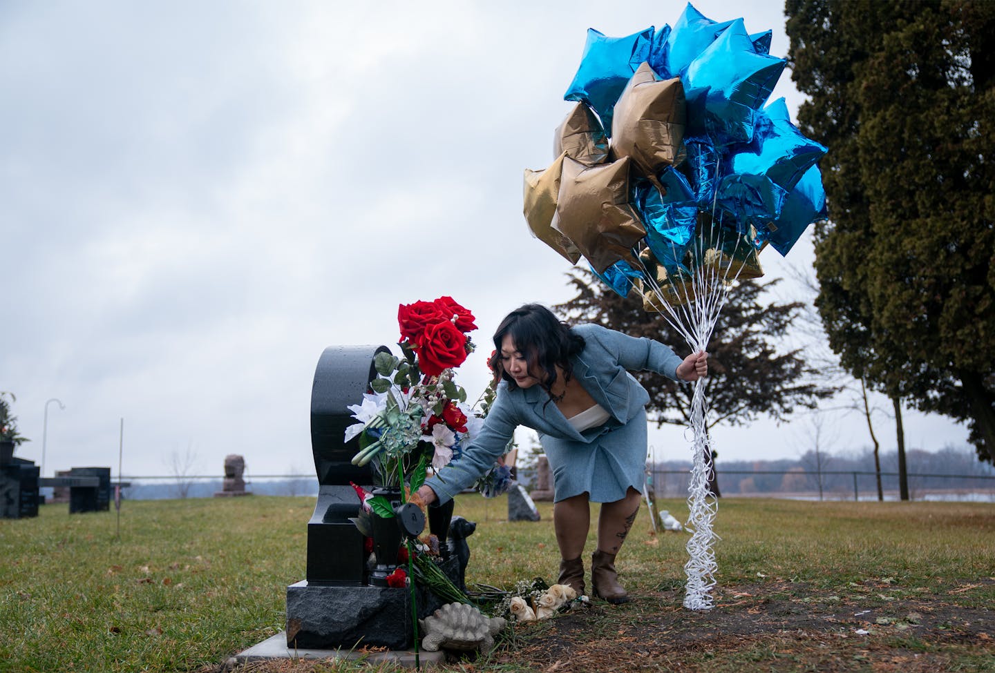 Baky Mikaele laid flowers on her son Jin Taylor’s grave at a primarily Hmong cemetery in Chisago City. Jin died at 14 years old from a bullet throug