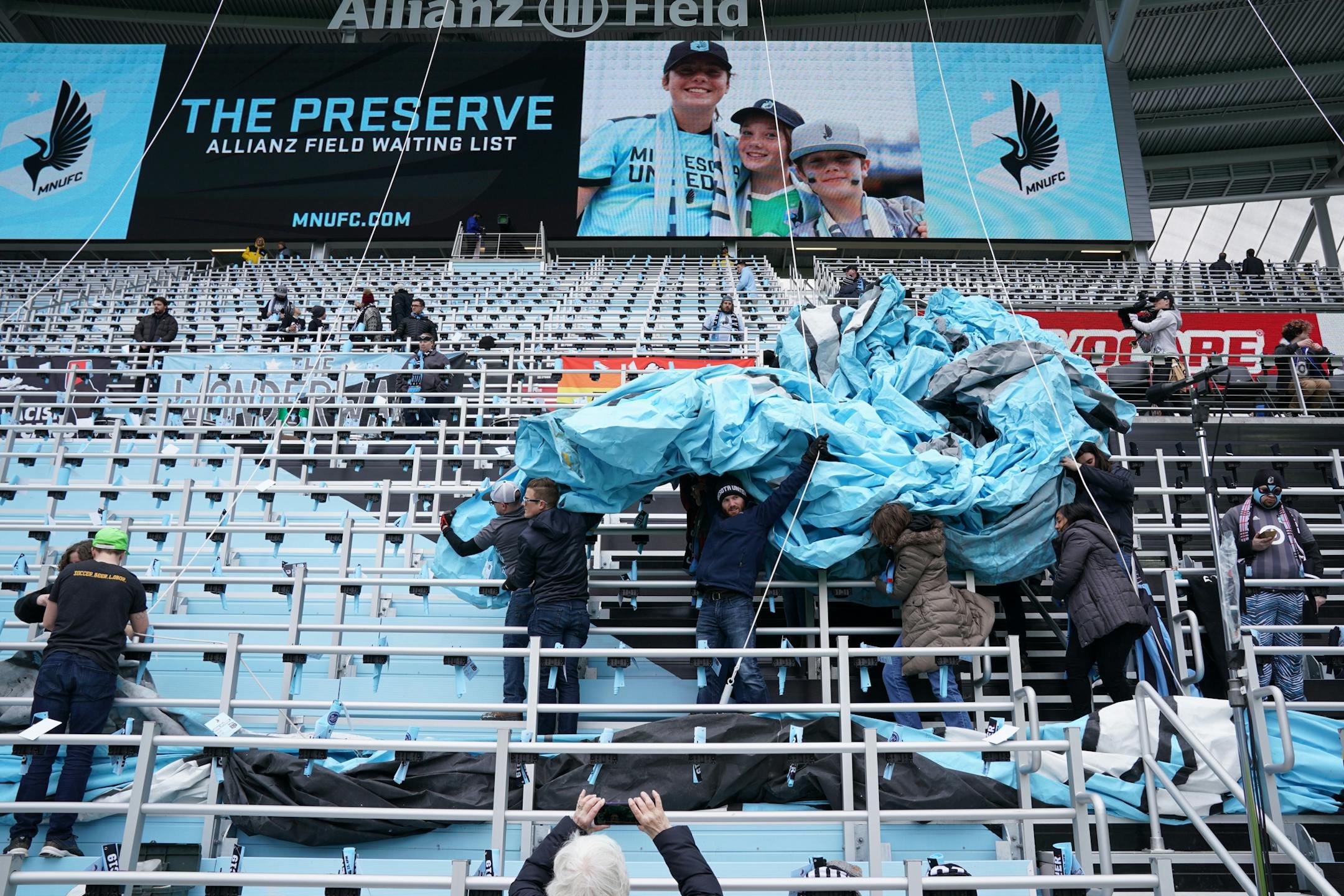 Fans helped carry in the Tifo ahead of Saturday's Minnesota United game against New York City at Allianz Field.