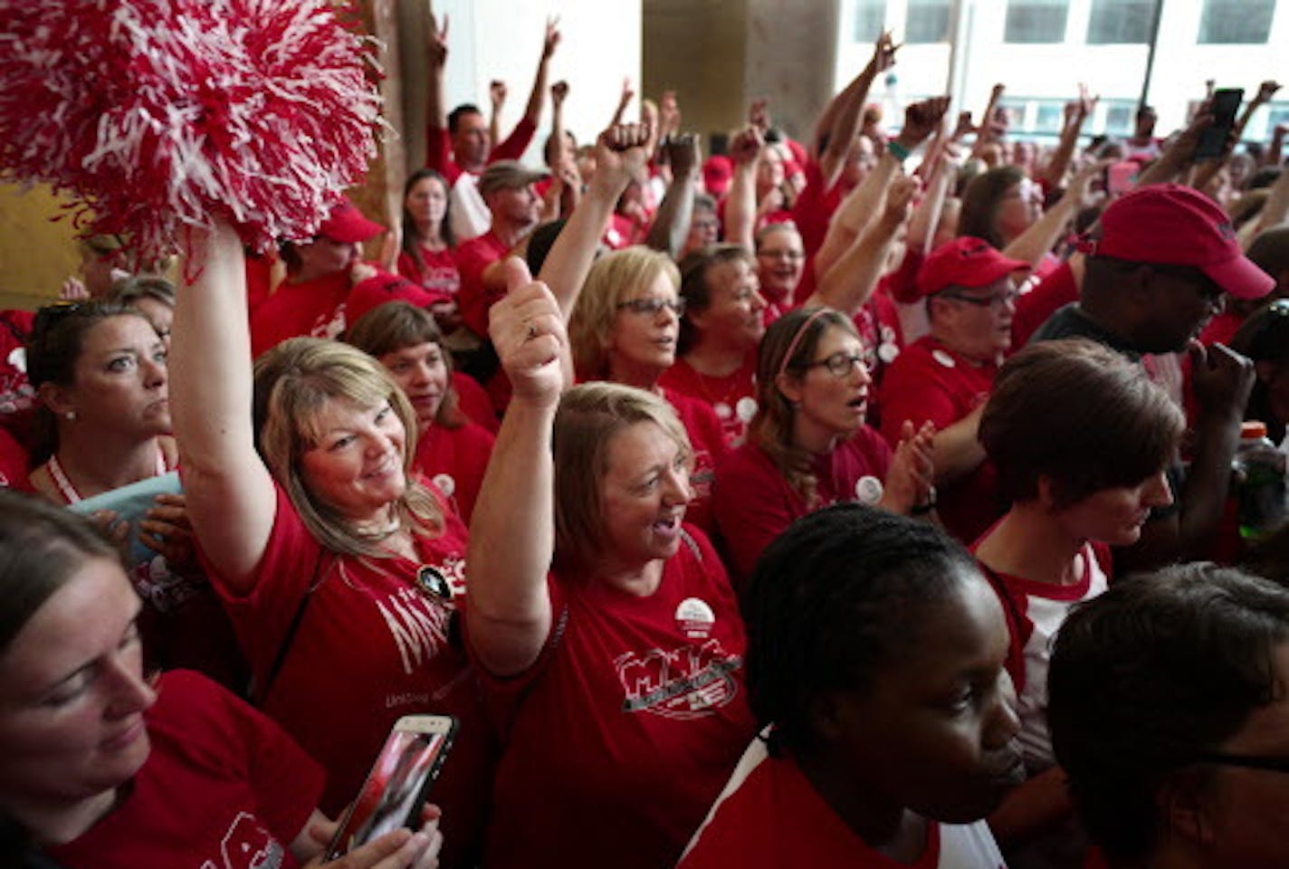 About 100 Allina Health nurses including Denise Frovarp (with pom poms) from Mercy Hospital in Coon Rapids, marched through the Capella building in downtown Minneapolis on Sept. 20 to demand a better contract.