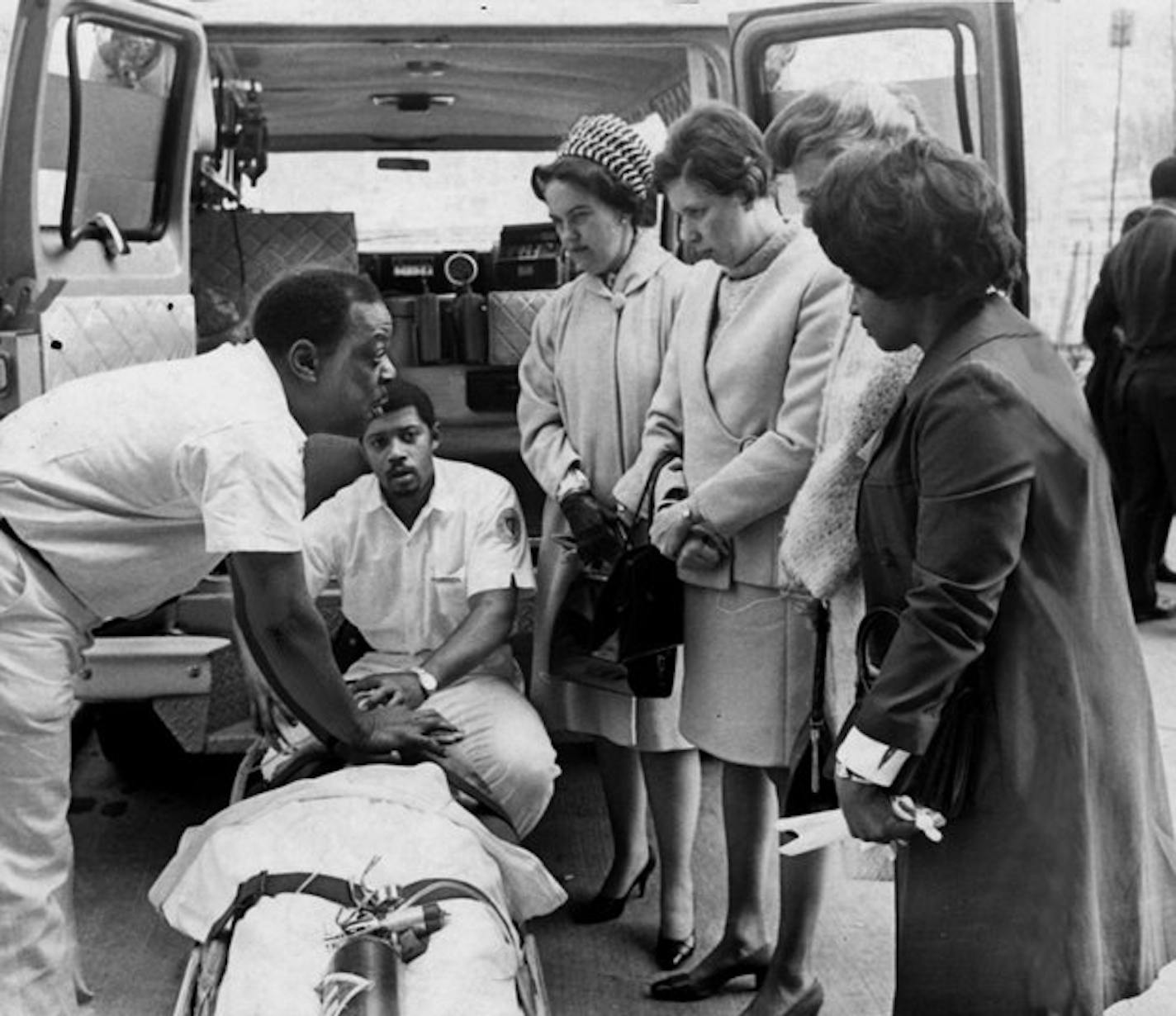 FILE: Freedom House paramedics demonstrate their new $13,000 ambulance, a vehicle especially equipped fro intensive care of patients en route to the hospital. Paramedics Carl Staten, left, and Eugene Key show their skills to onlookers, from left, Mrs. Margaret Clement, Mrs. Edward Hale, Mrs. C.D. Rea and Mrs. Dorothy Williams. The ambulances were unveiled today (April 8, 1969) at Chatham Center.