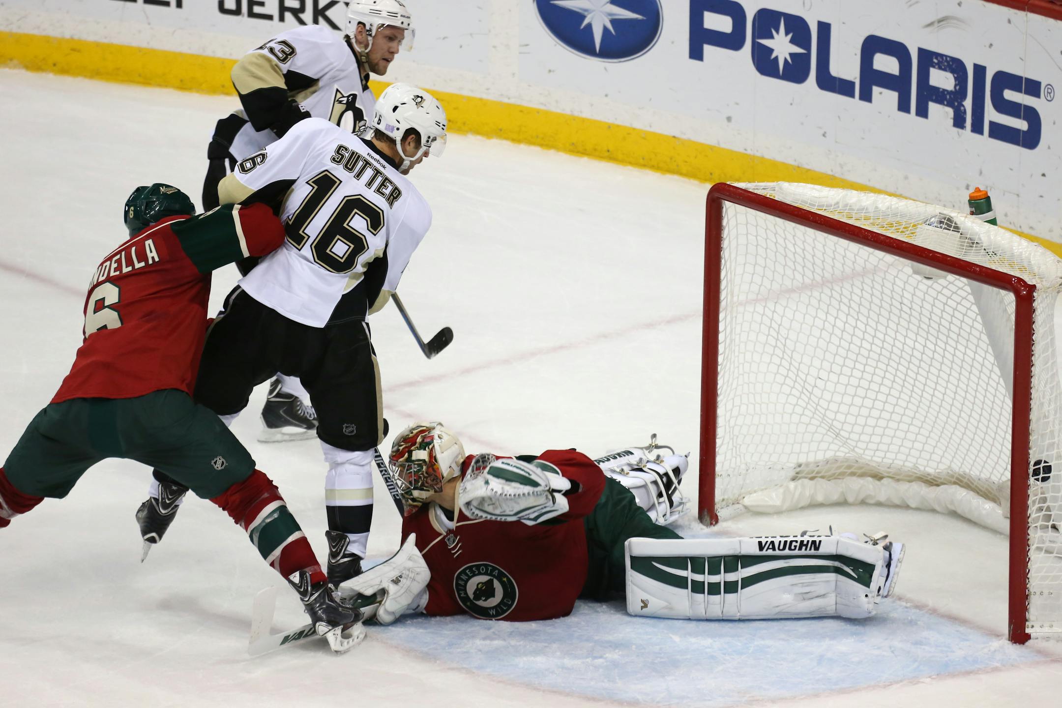 Pittsburgh Penguins' Nick Spaling, left rear, scores on Minnesota Wild goalie Darcy Kuemper during the first period of an NHL hockey game, Tuesday, Nov. 4, 2014, in St. Paul, Minn. (AP Photo/Bruce Bisping