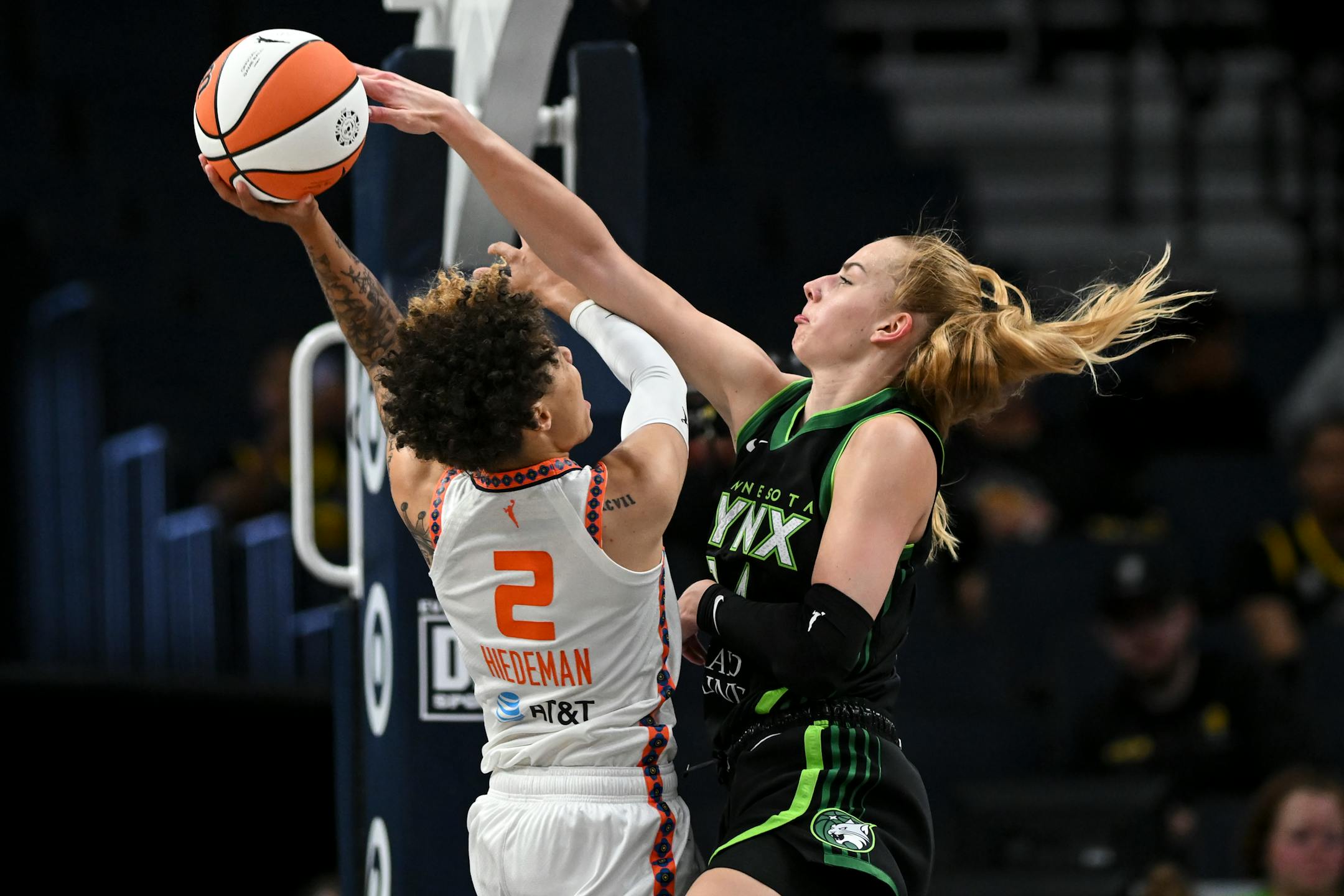 Minnesota Lynx forward Dorka Juhász fouls Connecticut Sun guard Natisha Hiedeman (2) as Hiedeman scores a basket during the first half of a WNBA basketball game Thursday, June 1, 2023, in Minneapolis. (Aaron Lavinsky=mnmi= ORG XMIT: MER77b77c0df423ea9bef9b91cb4eb7d