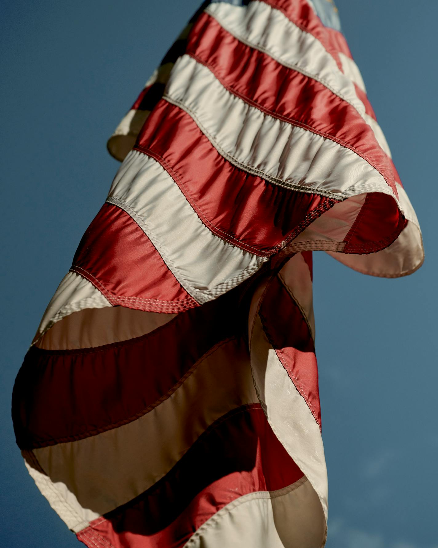 FILE — The American flag hangs at Rockefeller Center in New York, on April 11, 2020. "Because you're online so much you probably saw The Wall Street Journal/NORC poll that came out this week. It found that the share of Americans who say patriotism is very important to them has dropped to 38 percent from 70 percent since 1998," writes New York Times columnist David Brooks. (Vincent Tullo/The New York Times)