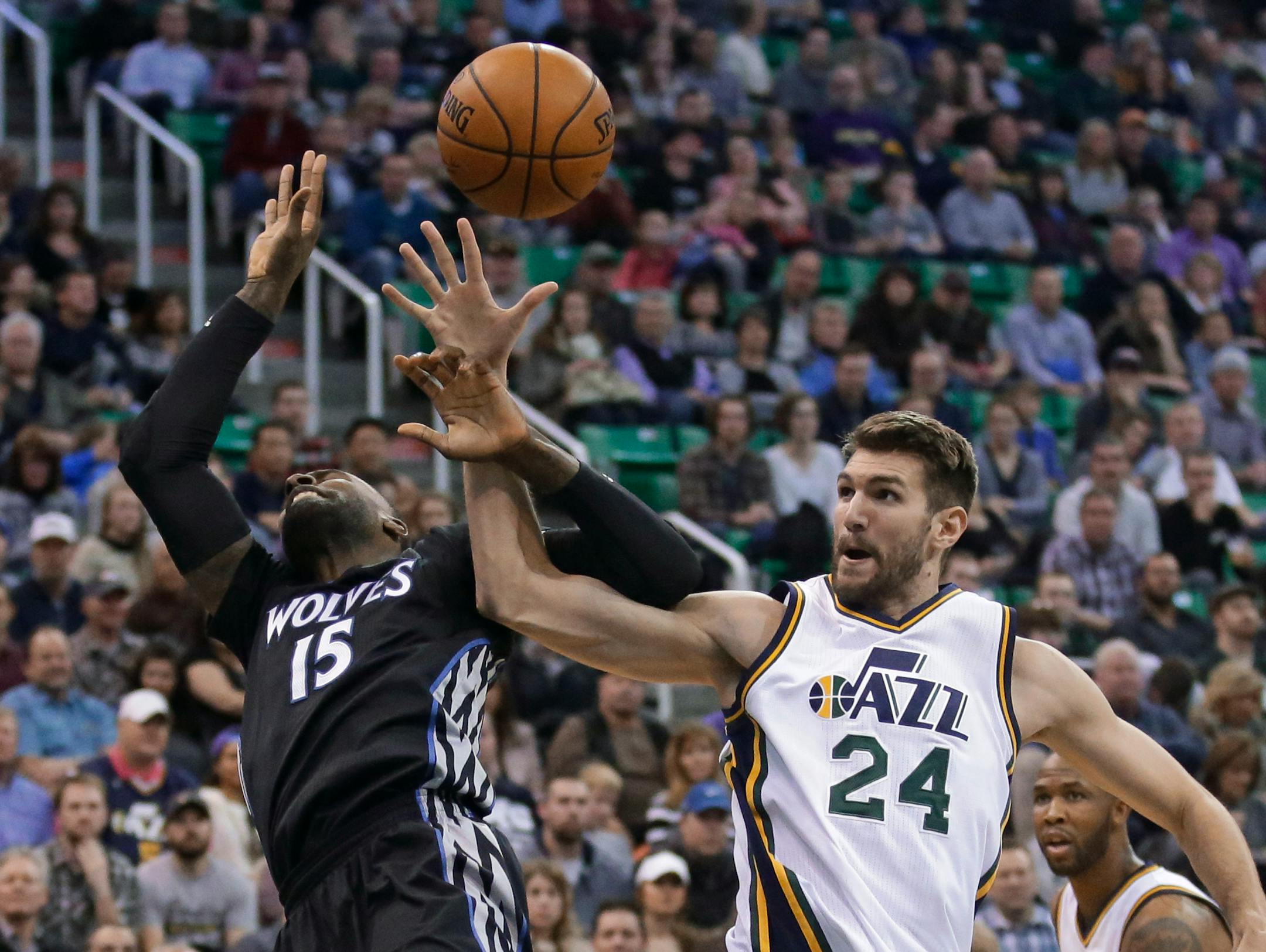Minnesota Timberwolves forward Shabazz Muhammad (15) and Utah Jazz center Jeff Withey (24) compete for a rebound during the second quarter of an NBA basketball game Friday, Jan. 29, 2016, in Salt Lake City. (AP Photo/Rick Bowmer)