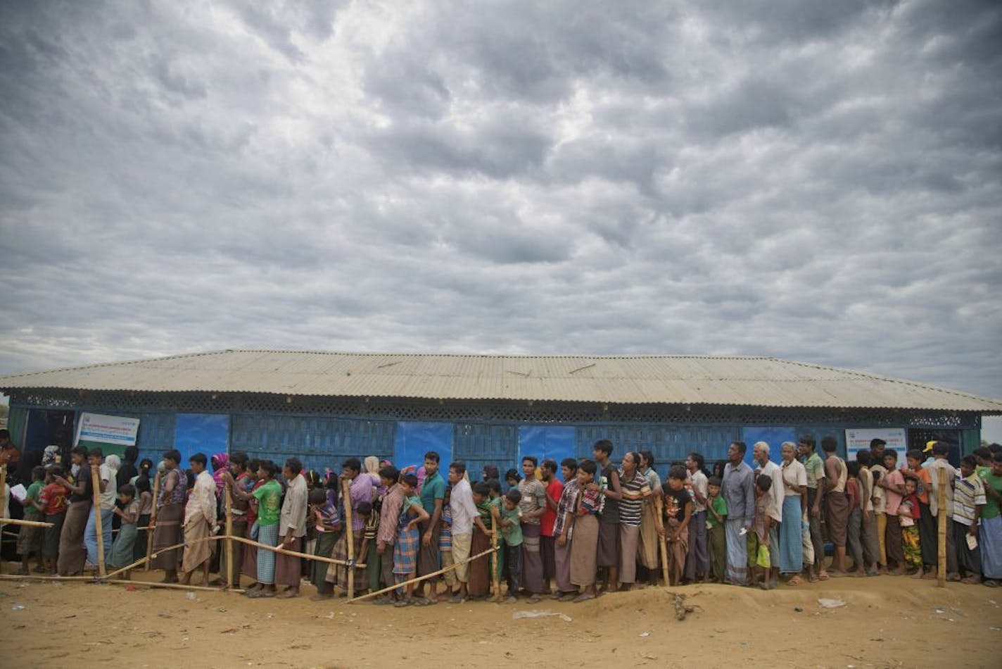 FILE - In this file photo dated Wednesday, Nov. 15, 2017, Rohingya Muslims, who crossed over from Myanmar into Bangladesh, wait in queues to receive aid at Kutupalong refugee camp in Ukhiya, Bangladesh. The human rights group Amnesty International says in annual report released Wednesday, Jan. 29, 2020 that while authoritarian controls are increasingly undermining freedoms in Asia, the will to resist such repression is also growing.