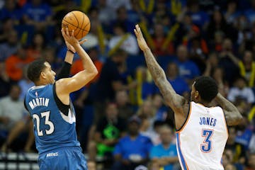 Minnesota Timberwolves guard Kevin Martin (23) shoots over Oklahoma City Thunder forward Perry Jones (3) in the first quarter of an NBA pre-season bas