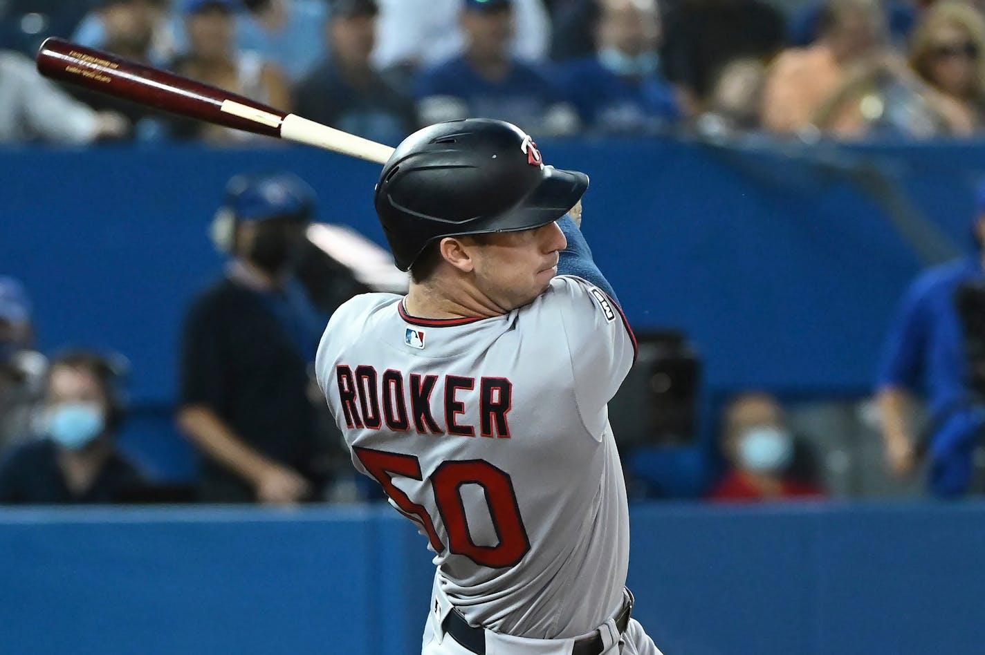 Minnesota Twins' Brent Rooker follows through on an RBI double against the Toronto Blue Jays during the second inning of a baseball game Friday, Sept. 17, 2021, in Toronto. (Jon Blacker/The Canadian Press via AP)