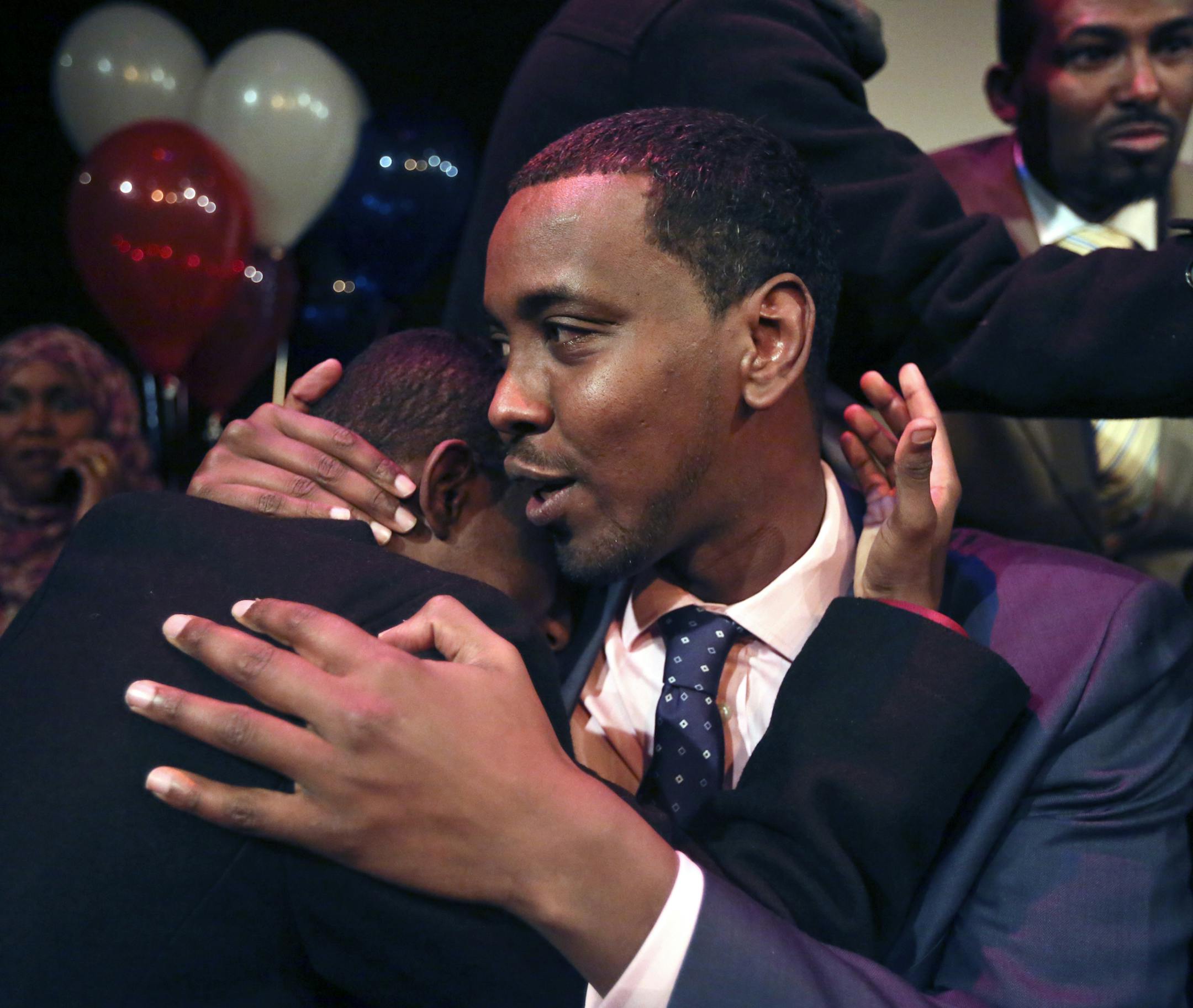 Following his landslide victory, Ward 6 City Council candidate Abdi Warsame gets a hug from volunteer Ali Saleh Tuesday, Nov. 5, 2013, in Minneapolis, Minn., at the victory party at Mixed Blood Theatre. (AP Photo/The Star Tribune, David Joles) ORG XMIT: MIN2013110610340012