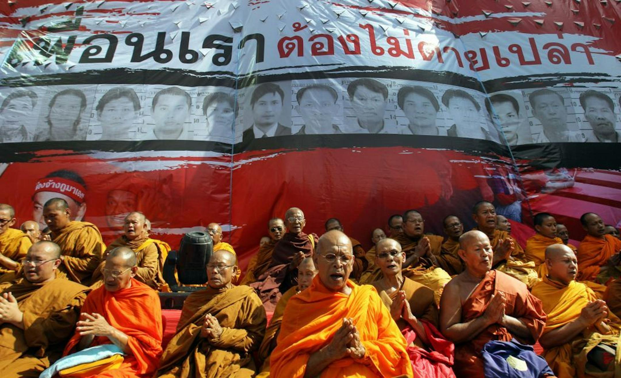 Buddhist monks attend a prayer session for Red Shirts victims in 2010 deadly street fighting, at Ratchaprasong Intersection in Bangkok, Thailand, Saturday, May 19, 2012. The Red Shirt protesters marked the second anniversary of the army's crushing of a two-month-long Red Shirt protest in central Bangkok, the most violent incident in political unrest that has wracked the country since Thaksin Shinawatra was ousted in a 2006 military coup.