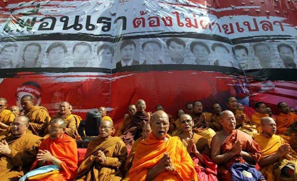 Buddhist monks attend a prayer session for Red Shirts victims in 2010 deadly street fighting, at Ratchaprasong Intersection in Bangkok, Thailand, Satu