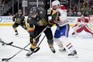 Vegas Golden Knights center Nicolas Roy (10) controls the puck next to Montreal Canadiens defenseman Jon Merrill (28) during the second period in Game