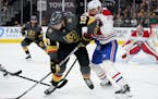 Vegas Golden Knights center Nicolas Roy (10) controls the puck next to Montreal Canadiens defenseman Jon Merrill (28) during the second period in Game