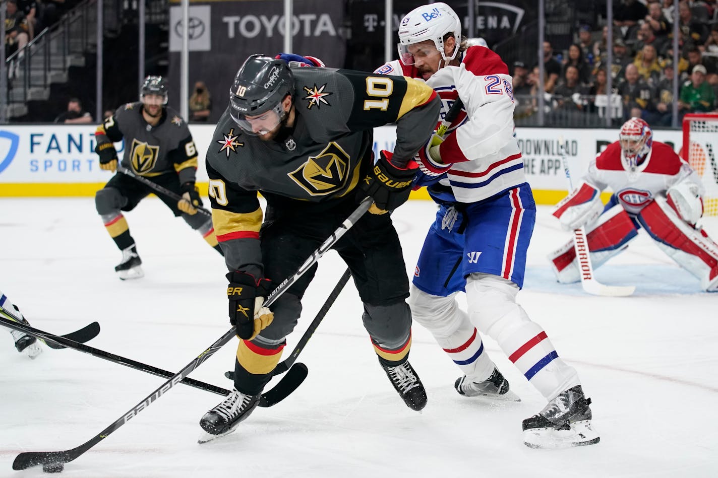 Vegas Golden Knights center Nicolas Roy (10) controls the puck next to Montreal Canadiens defenseman Jon Merrill (28) during the second period in Game 2 of an NHL hockey Stanley Cup semifinal playoff series, Wednesday, June 16, 2021, in Las Vegas. (AP Photo/John Locher)