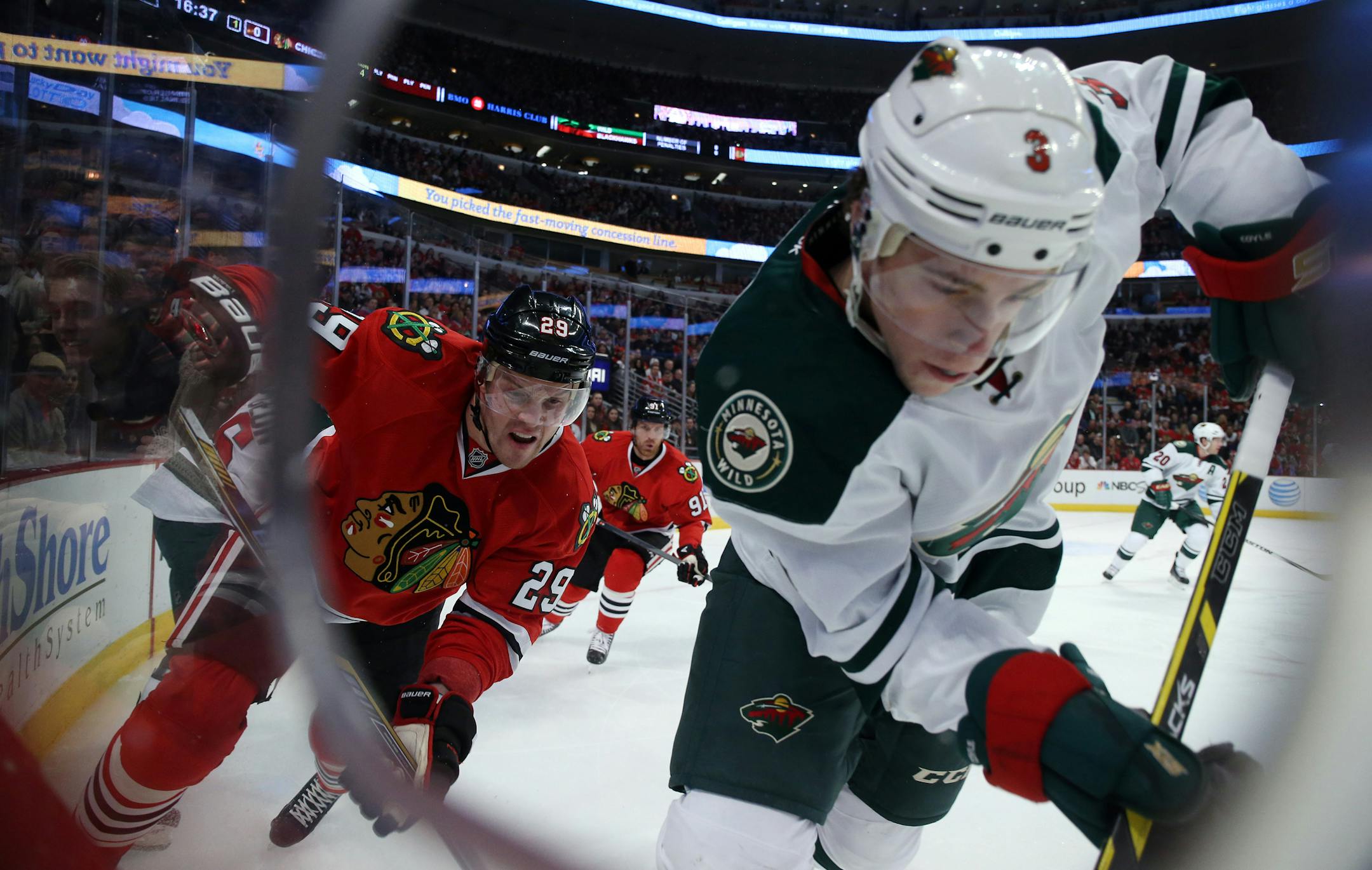 Chicago Blackhawks left wing Bryan Bickell (29) and Minnesota Wild center Charlie Coyle (3) along the boards during the first period on Sunday, Jan. 11, 2015, at the United Center in Chicago. (Brian Cassella/Chicago Tribune/TNS)