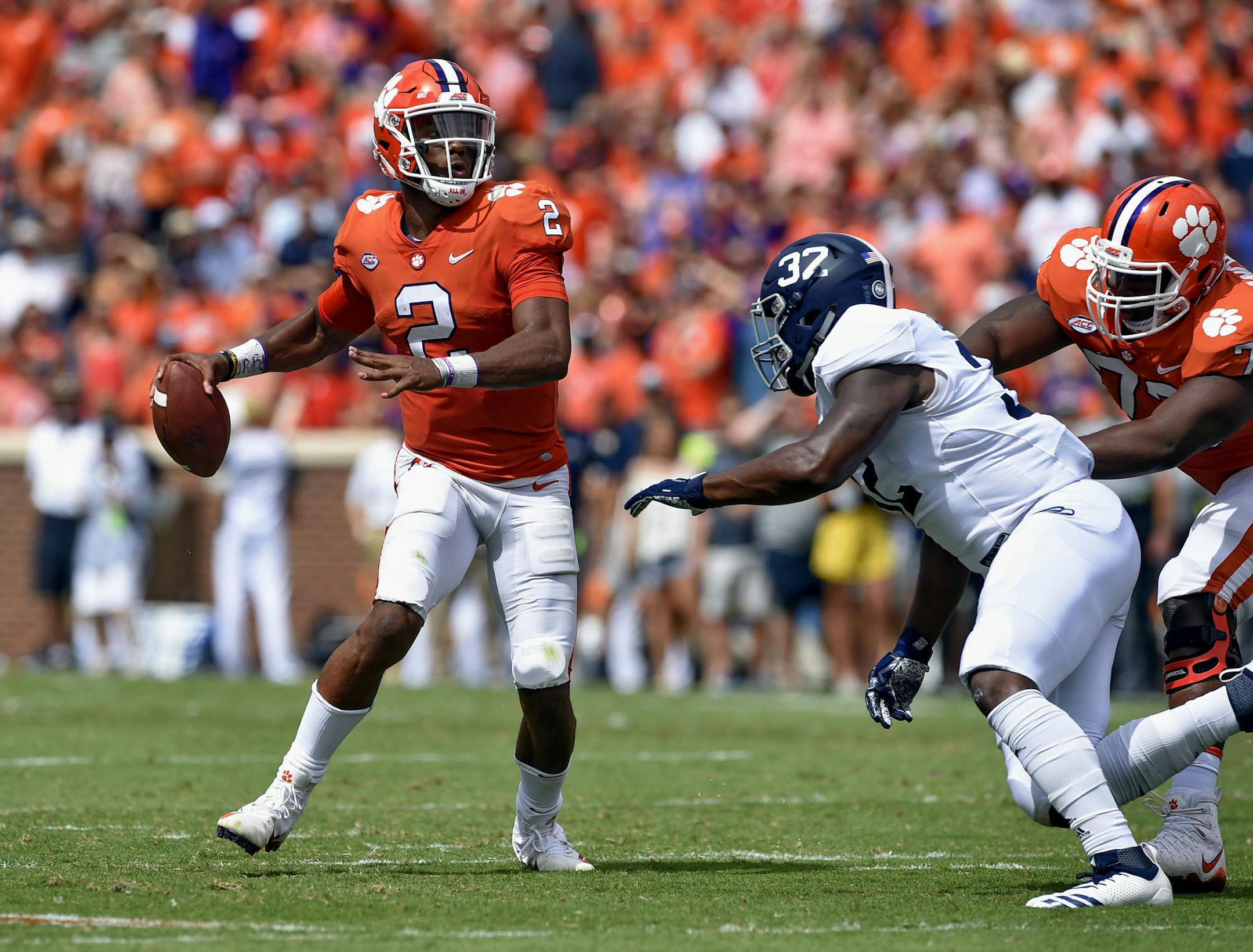 FILE - In this Saturday, Sept. 15, 2018, file photo, Clemson quarterback Kelly Bryant looks to pass while pressured by Georgia Southern's Lane Ecton during the first half of an NCAA college football game in Clemson, S.C. The Tigers remain committed to playing both incumbent starter Kelly Bryant and highly rated freshman Trevor Lawrence as they head into Saturday's Atlantic Coast Conference opener against struggling Georgia Tech. (AP Photo/Richard Shiro, FIle)