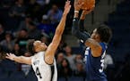 Minnesota Timberwolves' Robert Covington, right, shoots as San Antonio Spurs' Derrick White defends in the first half on Wednesday.