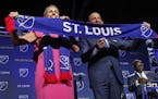 Carolyn Kindle Betz, a member of the ownership group of the new soccer franchise, and Major League Soccer Commissioner Don Garber display a St. Louis 