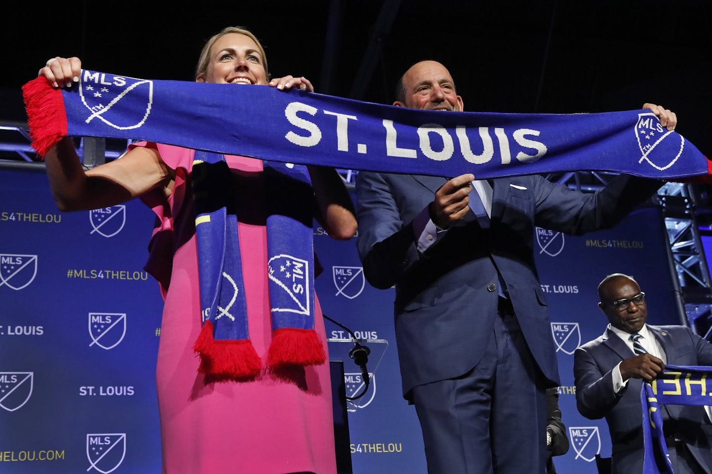 Carolyn Kindle Betz, a member of the ownership group of the new soccer franchise, and Major League Soccer Commissioner Don Garber display a St. Louis soccer scarf after the announcement Tuesday in St. Louis. MLS has awarded the next expansion franchise to St. Louis, where a new downtown stadium will be built and the team will begin play during the 2022 season.