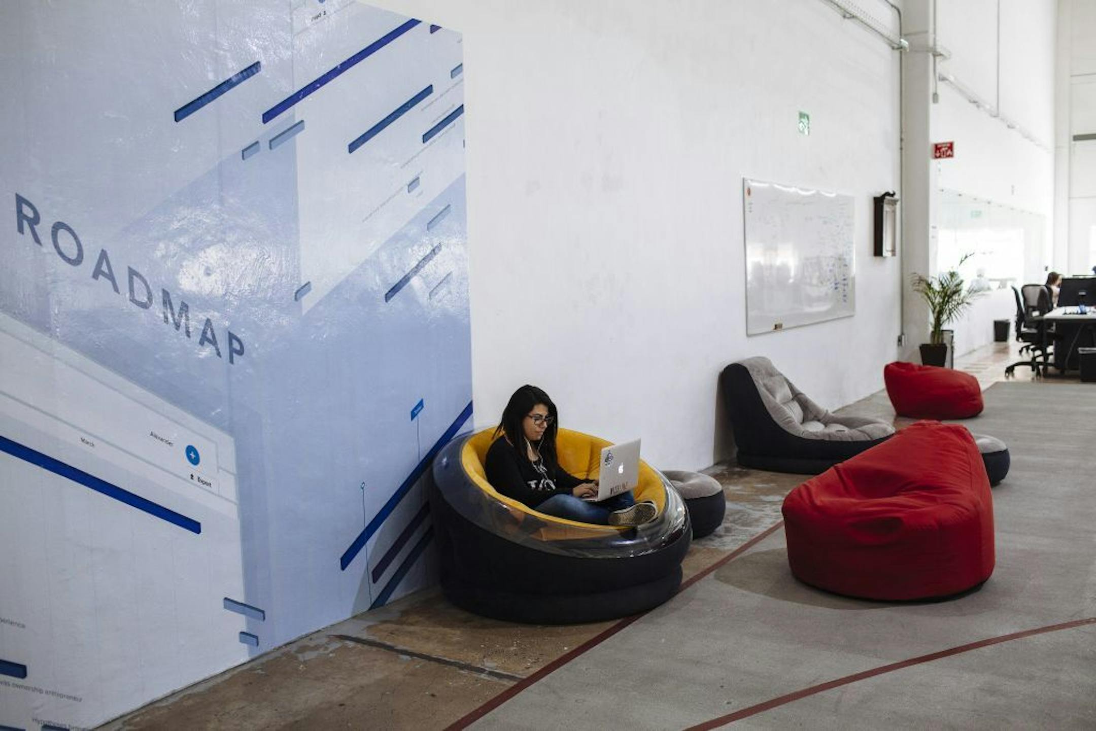 A woman works at the offices of Wizeline, a San Francisco-based startup, in Guadalajara, Mexico, May 11, 2017. While American entrepreneurs fret about the ramifications of an anti-immigration political climate, other countries, including Mexico and Canada, are sensing potential gains.