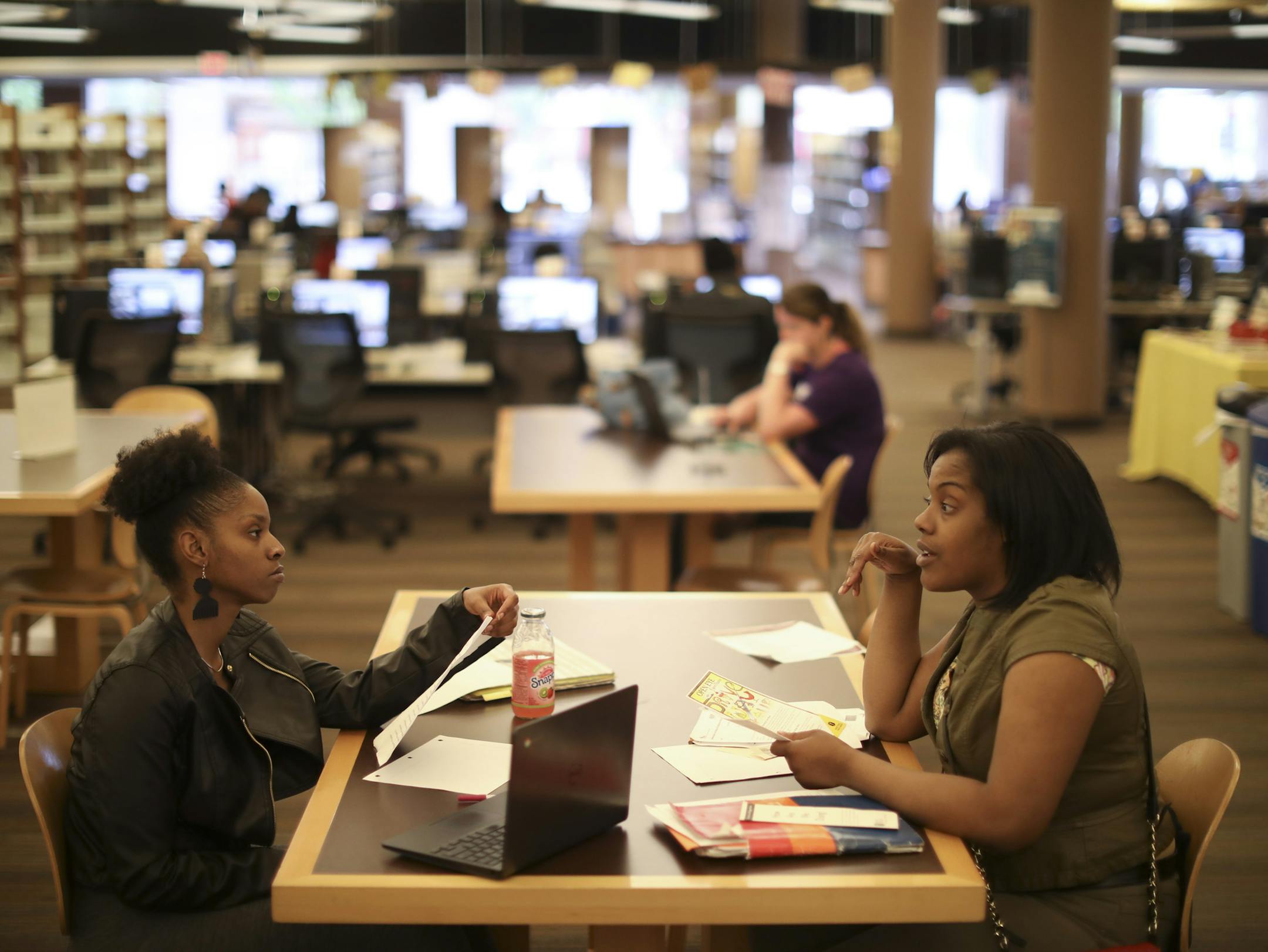 Mys Helen Martin, left, and Lanauja Curtis discussed work business, including, since they are heavy users of the Rondo Library, where they are going to meet once the library closes for the refresh. ] JEFF WHEELER &#xef; jeff.wheeler@startribune.com St. Paul is closing the busiest library branch in the city Thursday for the whole summer. The ten year-old Rondo Community Outreach Library is getting a refresh to better serve some of it's heaviest users: kids doing homework after school. People youn
