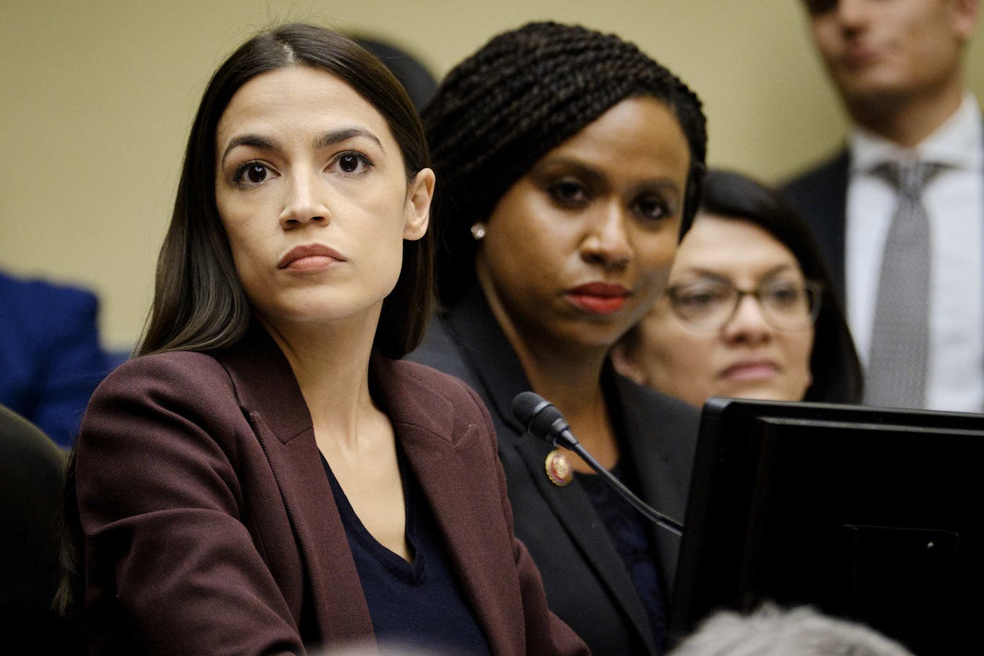 FILE-- From left: Reps. Alexandria Ocasio-Cortez (D-N.Y.), Ayanna Pressley (D-Mass.) and Rashida Tlaib (D-Mich.) during a hearing where Michael Cohen testified before the House Oversight and Reform Committee, on Capitol Hill in Washington, Feb. 27, 2019. Six months into the new House Democratic majority, long-simmering tensions between House Speaker Nancy Pelosi and the squad &#x2014; Rep. Ilan Omar (D-Minn.), Ocasio-Cortez, Tlaib and Pressley &#x2014; have boiled over in the most public of ways