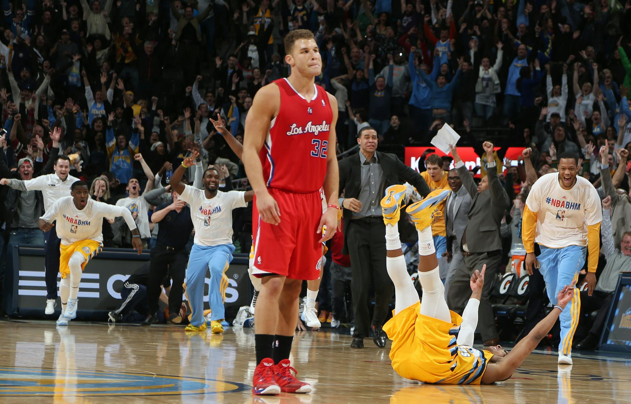 Los Angeles Clippers forward Blake Griffin, front, reacts as Denver Nuggets guard Randy Foye, celebrates after hitting a three-pointer with nine-tenths of second remaining in the fourth quarter of the Nuggets' 116-115 victory on Monday night in Denver.
