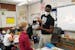 Shad Williams, a second-grade teacher at the School of Engineering and Arts in Golden Valley, talked with a student as the class worked through a less