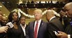 Republican Presidential candidate Donald Trump, center, joins a group of African-American religious leaders to speak to reporters in New York, Monday,
