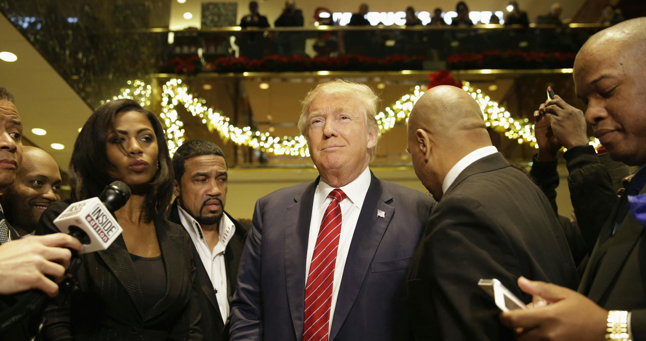 Republican Presidential candidate Donald Trump, center, joins a group of African-American religious leaders to speak to reporters in New York, Monday, Nov. 30, 2015. Trump met with a coalition of 100 African-American evangelical pastors and religious leaders in a private meeting at Trump Tower. (AP Photo/Seth Wenig)