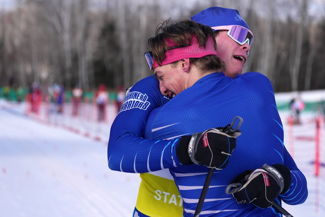 Brainerd's Lance Hastings hugged teammate Taite Knapp after he crossed the finish line to give their team a victory in the boys team sprint.