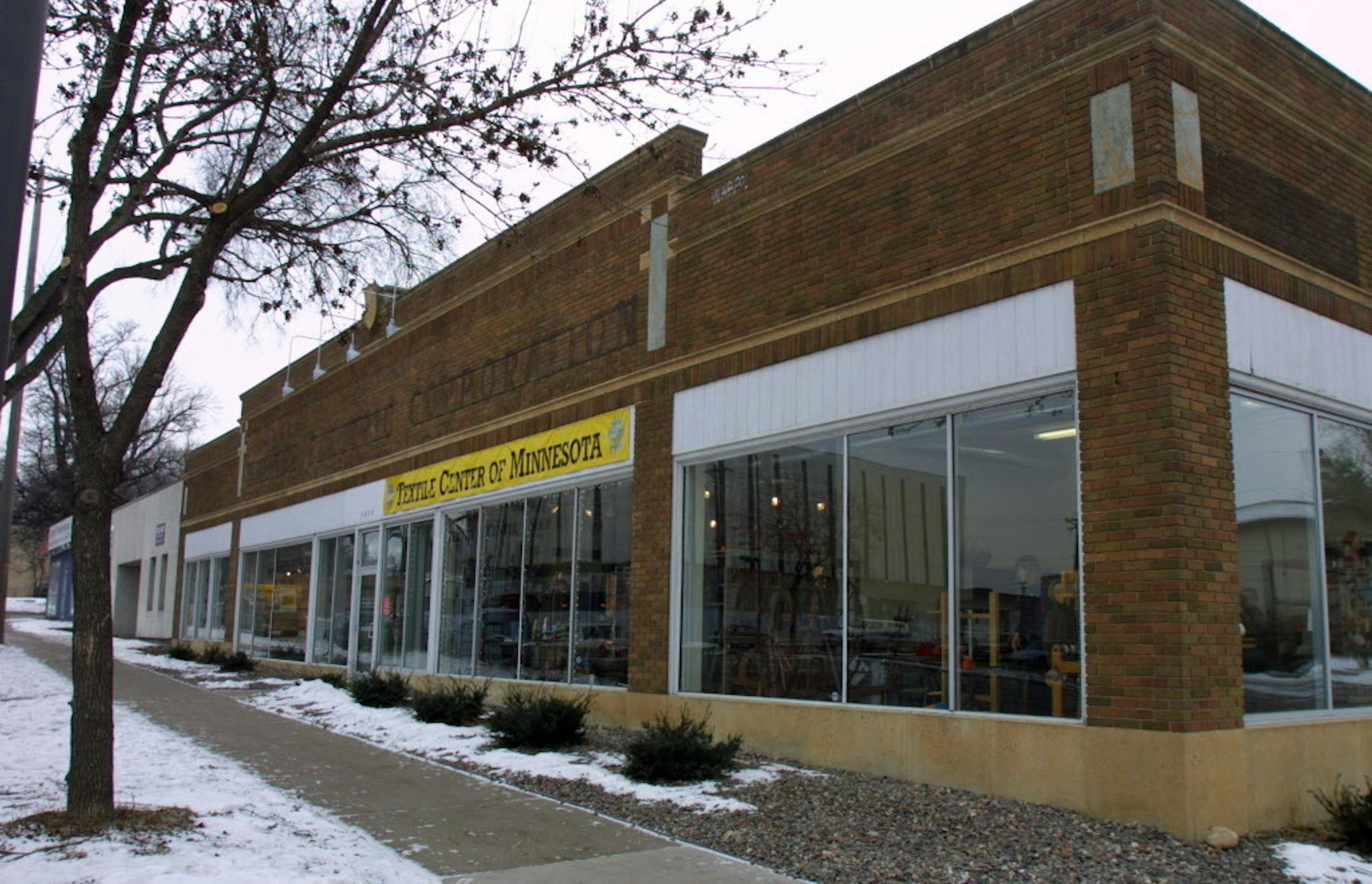 Minneapolis, MN., Thursday, 1/31/2002.  Exterior of the new Textile Center on University Ave in Minneapolis.  As lede story for Freetime Visual Arts page, we need pix of exterior and interior spaces at new Textile Center which has grand opening Saturday, 9 Feb. It's a converted auto showroom with nice architectural detailing -- good clean lines, handsome doors, a library and weaving studio and auditorium, plus gallery, shop, offices. Story will be about its development, goals, people involved. Its an umbrella organization for weavers, quilters, lacemakers etc. NEED PIX also of Margaret Miller, executive director and founder. And maybe some details of intersting stuff in shop or exhibition -- handmade clothes? hats? (I haven't been there recently - so don't know what's available or what would make a great batch of pix.