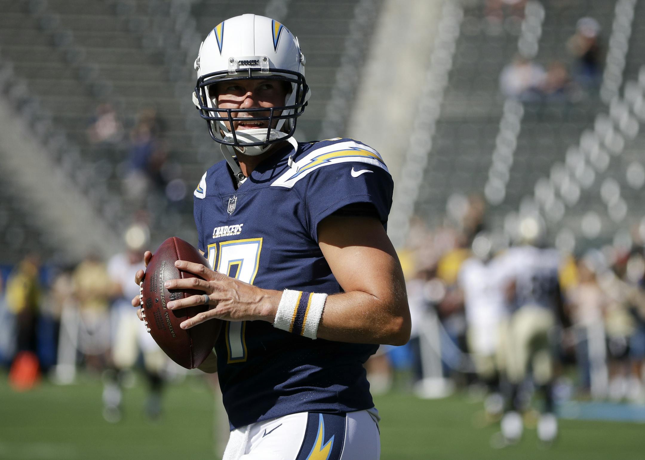 FILE - In this Aug. 20, 2017, file photo, Los Angeles Chargers quarterback Philip Rivers warms up before an NFL preseason football game against the New Orleans Saints in Carson, Calif. Rivers is commuting from his familyís home in San Diego to the Chargersí new training complex in a $200,000 RV this season. Even though he didn't move his wife and eight children north when the Chargers relocated, the veteran quarterback is eager to lead the Chargers' rebound when he begins his 12th seas