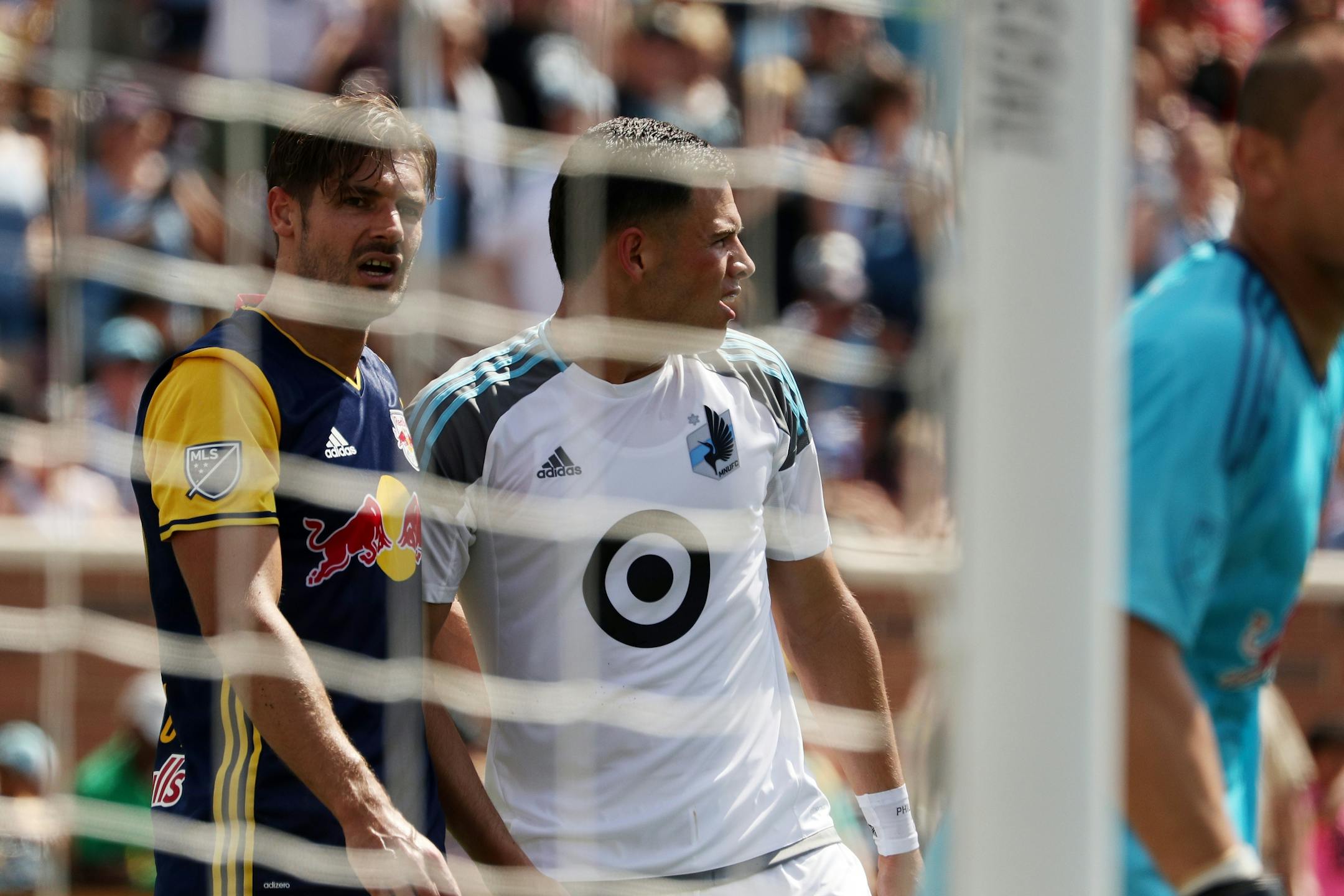 Minnesota United forward Christian Ramirez (21) was marked by New York Red Bulls defender Damien Perrinelle (55) near the New York Red Bulls goal in the first half.