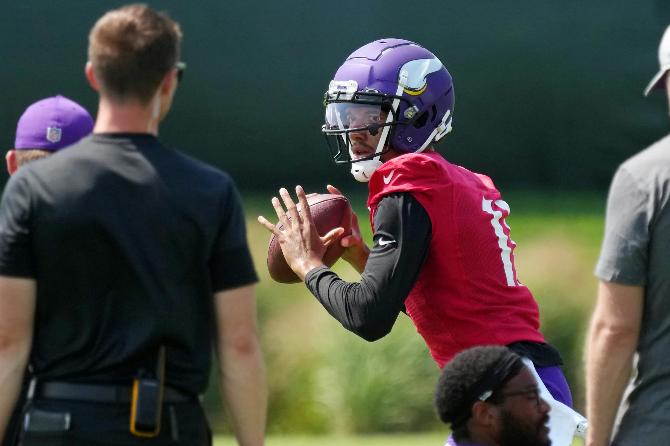 Minnesota Vikings quarterback Kellen Mond (11) drops back to throw a pass during training camp.