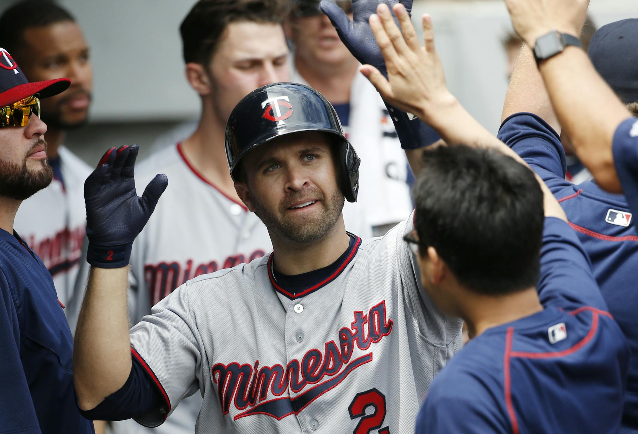Minnesota Twins' Brian Dozier celebrates with teammates in the dugout after hitting a solo home run during the fourth inning of a baseball game against the Chicago White Sox in Chicago, Thursday, June 30, 2016. (AP Photo/Nam Y. Huh)