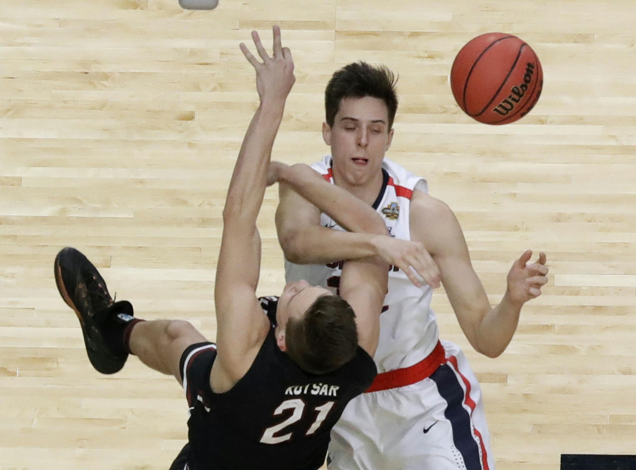 Gonzaga forward Zach Collins blocks a shot by South Carolina forward Maik Kotsar (21) during the second half in the semifinals of the Final Four NCAA college basketball tournament, Saturday, April 1, 2017, in Glendale, Ariz. (AP Photo/David J. Phillip)