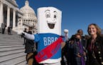 A man dressed as the Build Back Better bill wears a sash saying “on to the Senate” after the House approved the legislation on Nov. 19.