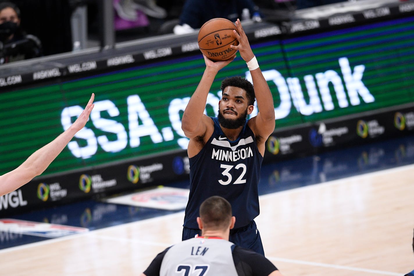 Minnesota Timberwolves center Karl-Anthony Towns (32) shoot against Washington Wizards center Alex Len, foreground, during the second half of an NBA basketball game, Saturday, Feb. 27, 2021, in Washington. (AP Photo/Nick Wass)