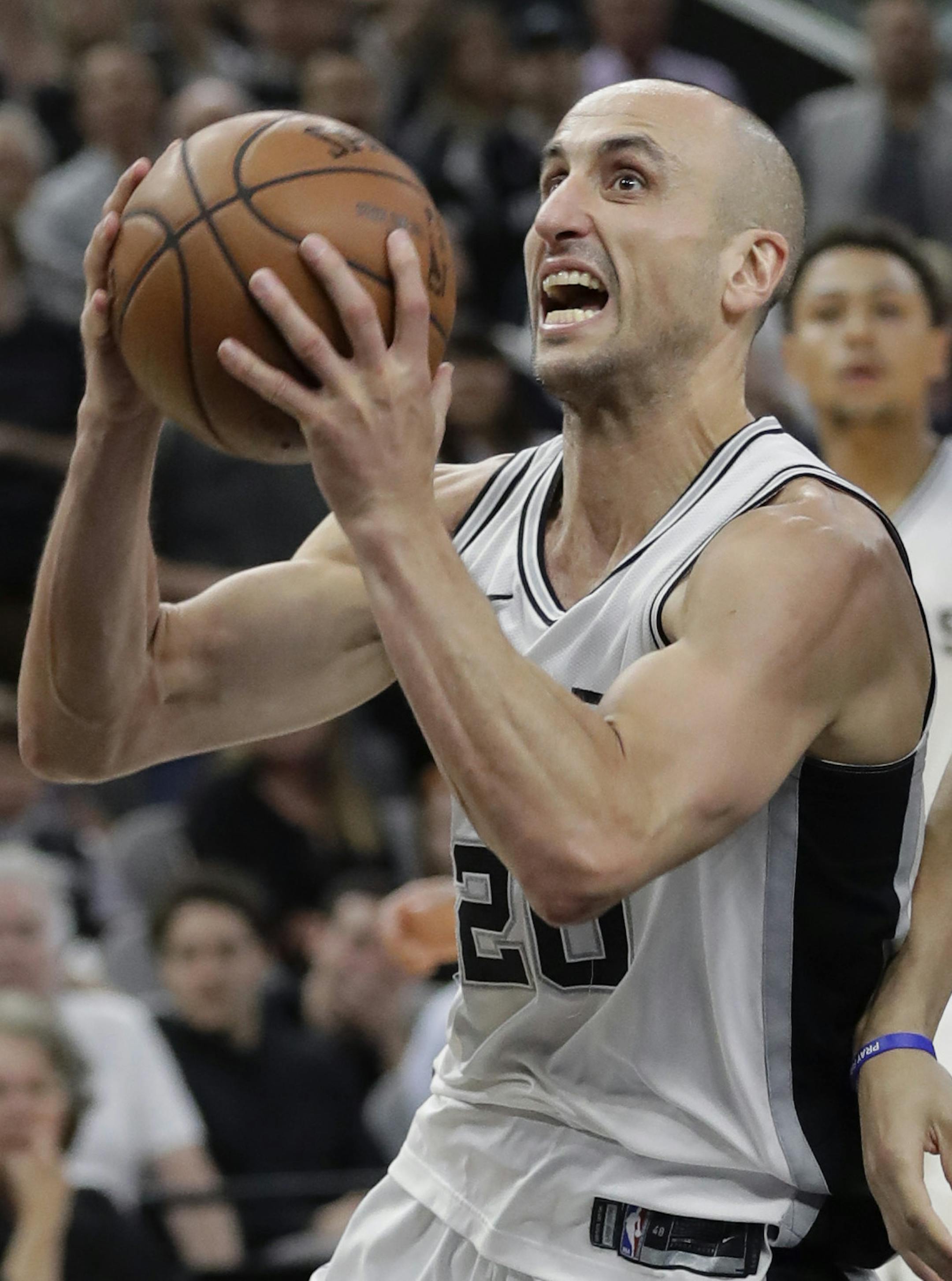 San Antonio Spurs guard Manu Ginobili (20) drives to the basket past Sacramento Kings forward Justin Jackson (25) during the second half of an NBA basketball game, Monday, April 9, 2018, in San Antonio. (AP Photo/Eric Gay) ORG XMIT: TXEG108