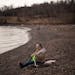 Colleen Sievert of Silver Bay sat on the shore of Lake Superior near the Split Rock River and looked for agates Sunday afternoon. Warm weather has bee
