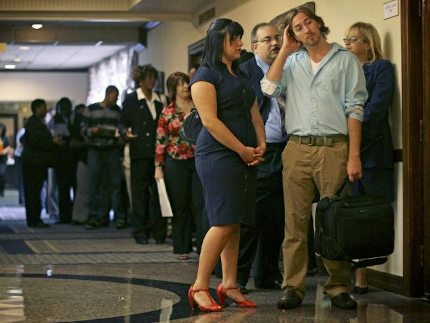 In this Aug. 24, 2010 photo, Lauren McFall, left, and Dan Edgar, both of Jersey City, N.J., wait on line at a career fair in Newark, N.J. "We seem to be in the early stages of what might be called a 'growth recession,'" said Ethan Harris, an economist at Bank of America-Merrill Lynch. The economy is likely to keep expanding, but at a snail's pace and without creating many more jobs.